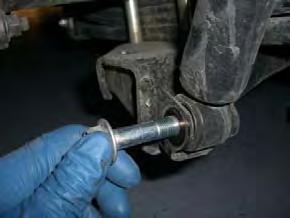 Insert 1 Remove the 12mm emergency brake line retaining bracket bolt.