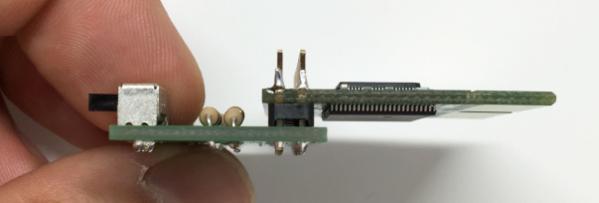 With the two boards placed together, solder one or two pins on the connector and then