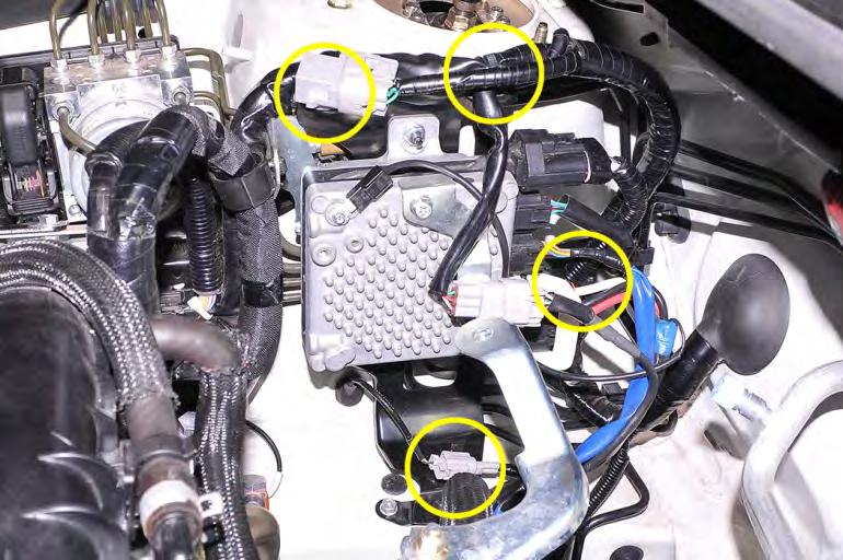 19. Remove the (4) wiring harness retaining clips from the ECU mounting