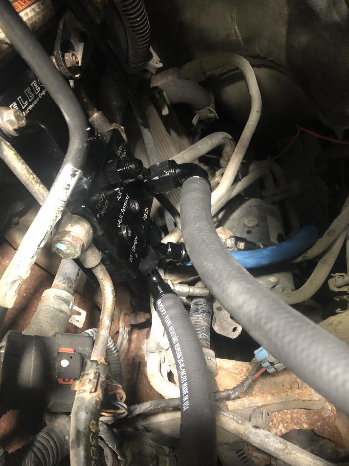 Take your section of -6 pushlock hose and a 90 degree fitting and put them together and install that end onto the aux return, take your section of -8 pushlock hose and a -8AN 90 degree fitting put