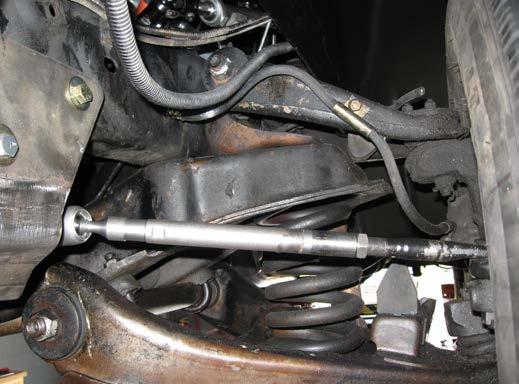 (Securely placing jack stands under the lower control arms and lowering the car onto the jack stands accomplishes this.