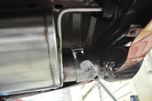 Slide the tip assembly over the muffler outlet pipe and tighten the clamp using the ratchet and 15mm deep socket until the tip assembly is snug on the muffler outlet pipe.