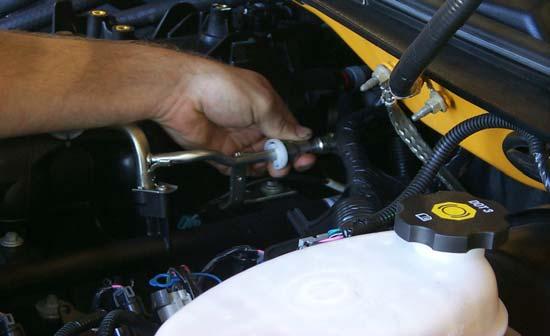 With the fuel line disconnect tool supplied, remove the fuel line