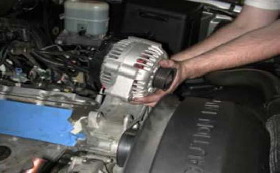 68. With a 15mm socket wrench remove the two bolts holding the alternator to
