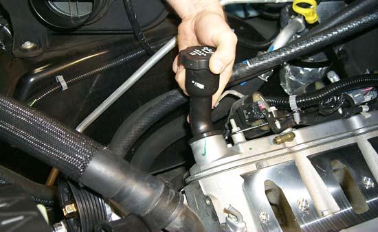 Remove the long oil fi ller neck from the valve cover by rotating it 180