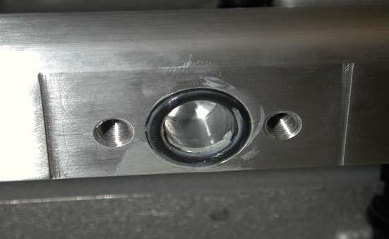 Apply a small amount of grease to the new supplied fuel manifold O-ring and set in the