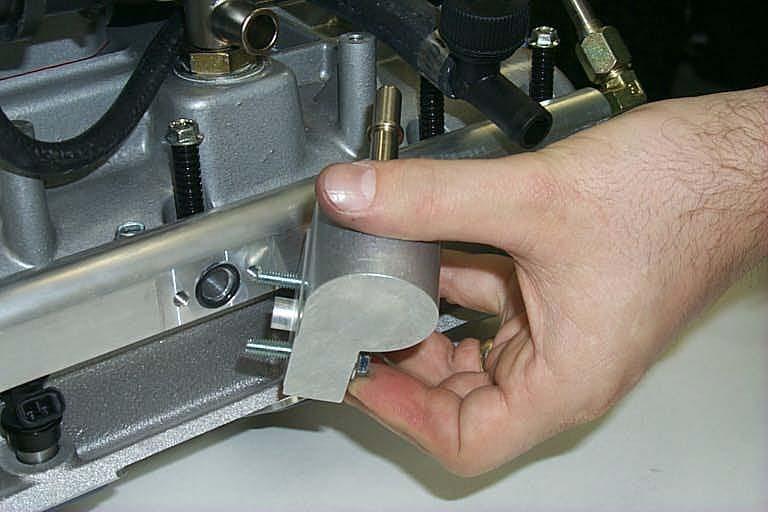 Install the assembled fuel manifold to the driver side fuel rail using the two new