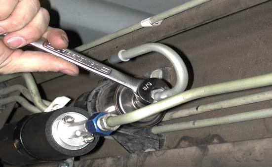 While supporting the pump using back-up 7/8 wrench, tighten