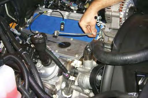 Using a 10mm socket wrench remove the two coolant vent