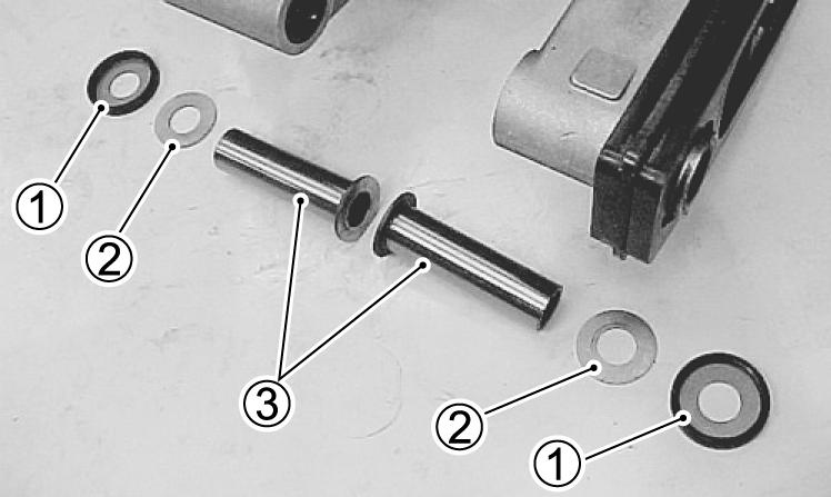 9. Remove the dust covers (1), washers (2), and spacers (3) from the swing arm; then