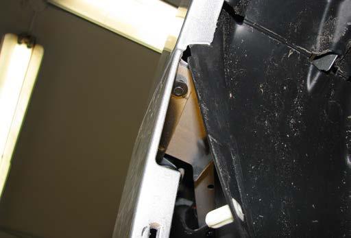 Using a 7MM socket, remove the three (3) screws from along the edge of the