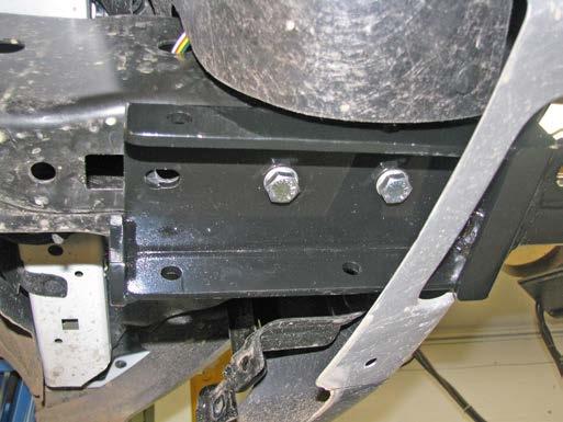 Drill out the existing hole in the belly pan bracket with a 17/32 drill bit.