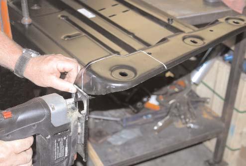 Remove the six retaining bolts that attach the Transfer Case