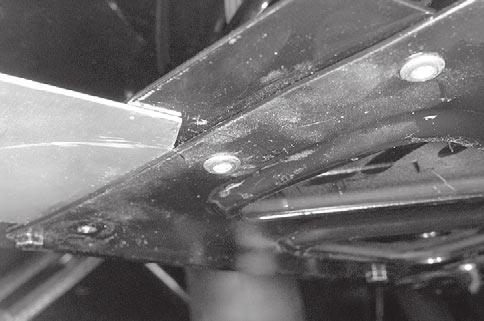 Unfasten swing arm at rear pivot. NOTE: While drilling on bottom pan, use light pressure on tool to avoid rivet head to turn. Drill all rivets retaining half bottom pan to be removed.