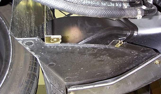 26. The shield installs next to the driver s side brake cooling duct and blocks the open area between where the filter goes and the hot engine compartment.