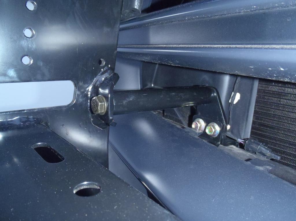 Starting on the drivers side, identify the mounting tab on the push bar shown in Figure 12.