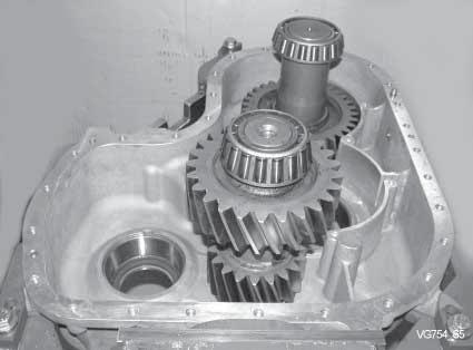 gear and front axle output shaft into housing. Mount housing cover for bearing setting.