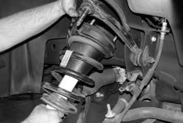 Starting on the driver side of the truck, remove the bolt attaching the brake line tab to the