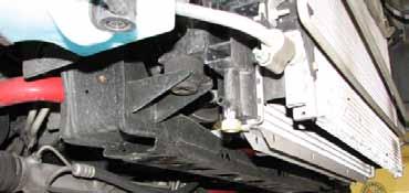 Disconnect the lower hoses joining the thermostat housing to the radiator, engine block and the bottom of the