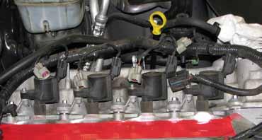 91. Use a 7mm socket to remove the bolt that secures each ignition coil, then use a slight twisting motion to remove the coils. 97.