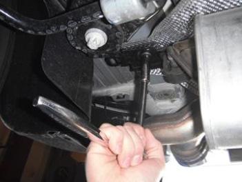 Use a 13mm socket to remove the (1) nut on each of the (2) rearward