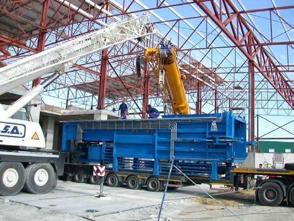 Once a container is full, the side arms which hold the container in position while compaction takes place, are released.