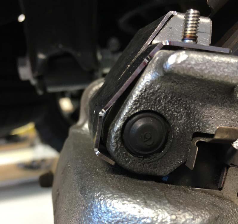 closed end over the stud on the caliper mounting