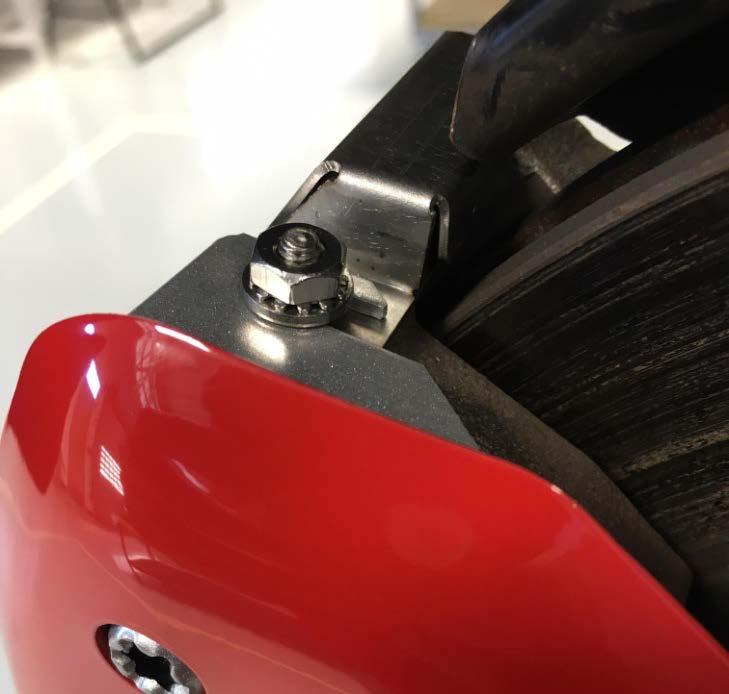 Push the caliper cover back until it touches the caliper and is a minimum of 3mm away from the rotor.