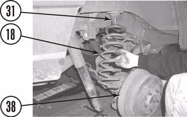 3. Remove passenger side coil spring. a.