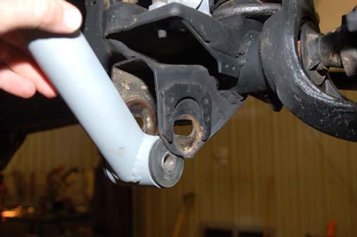 Using a 21mm socket and 18mm wrench install the lower control arm in the axle mount.