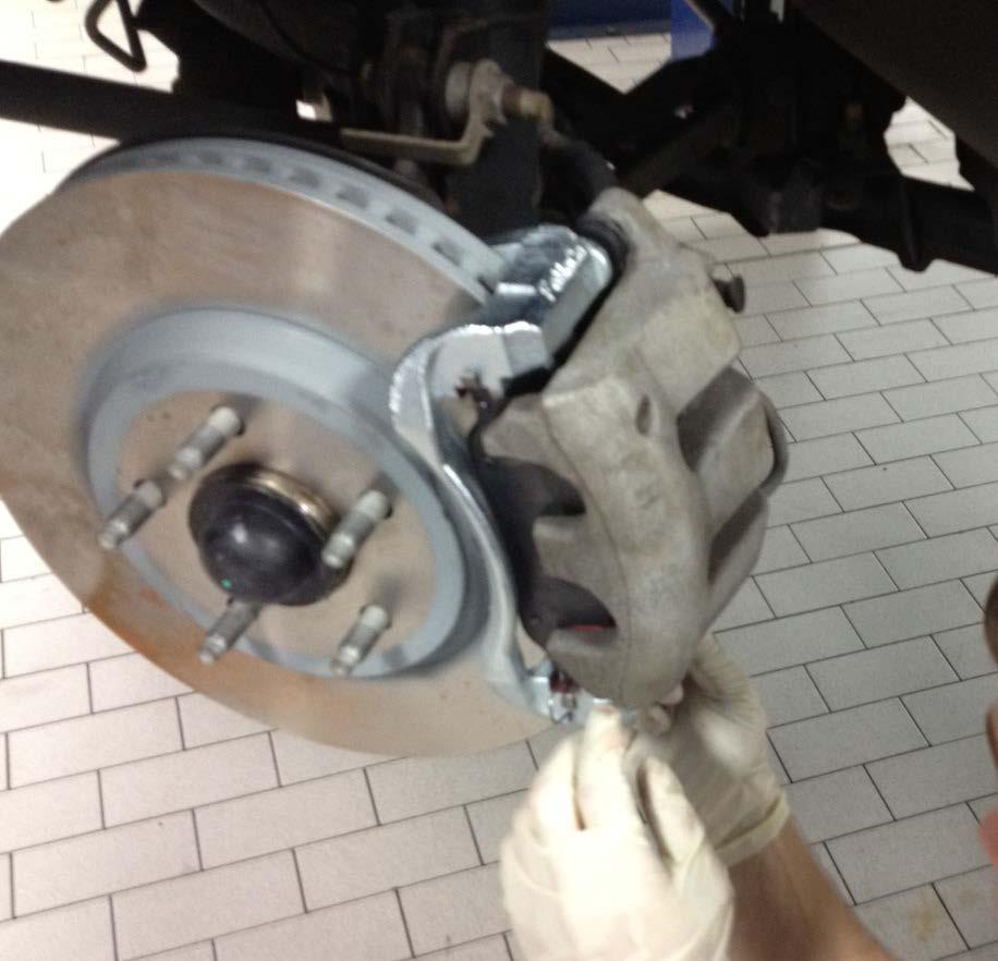 14. Reinstall the caliper over the new brake pads.