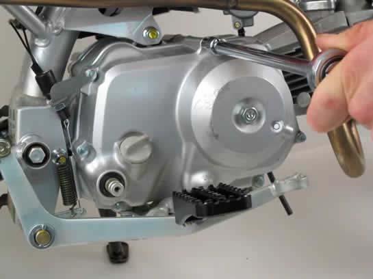 C2. To begin the process, drain the engine oil and remove the foot peg mount.