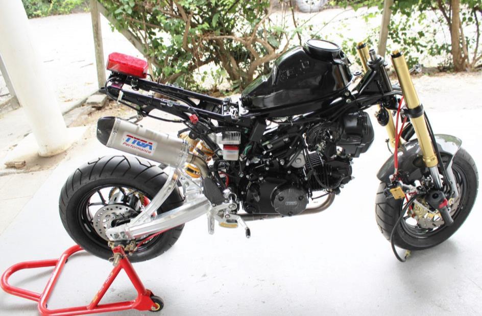 ) Remove seat, exhaust muffler, seat cowling, seat opening latch and rear fender. Re- move, tank shrouds, tank cover.