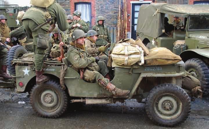 A jeep loaded with paratroopers of the 101st Airborne
