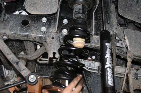 Jack up the rear axle and replace lower shock bolts.