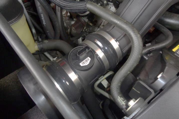Adjust the intake tube as necessary to avoid contact with surrounding components (such as the radiator hoses).
