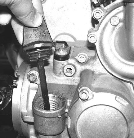Subsection 08 (LUBRICATION SYSTEM) OIL CHANGE Removal Place a drain pan under the engine magnetic drain plug area. Clean the magnetic drain plug area. Unscrew magnetic drain plug no.