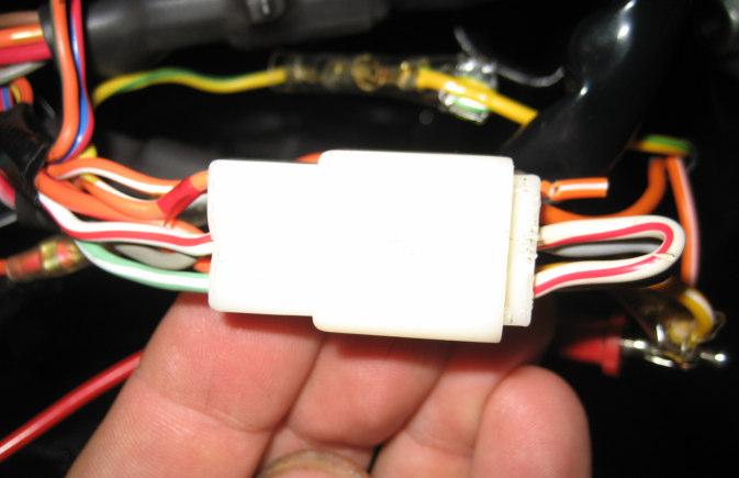 This is the connector in the headlamp that has a stator wire loop back from the legacy routing of the stator wires through the left hand switch.