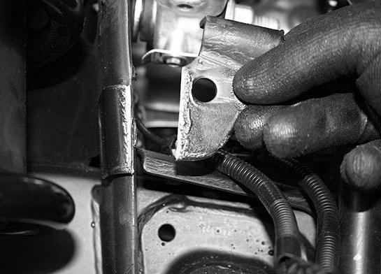 Using a cutoff wheel remove this tab completely off the mount and sand to a smooth finish. SEE FIGURE 18-19 17. Check front end alignment and set to factory specifications. Readjust headlights. 18. Recheck all bolts for proper torque.