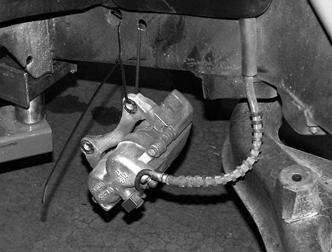 Starting on the passenger side of the truck, remove the two bolts securing the brake caliper to the spindle.
