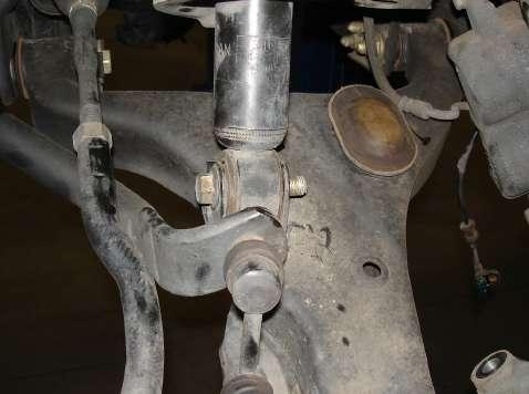 Starting on the driver s side, remove the lower strut bolt from the lower control arm.