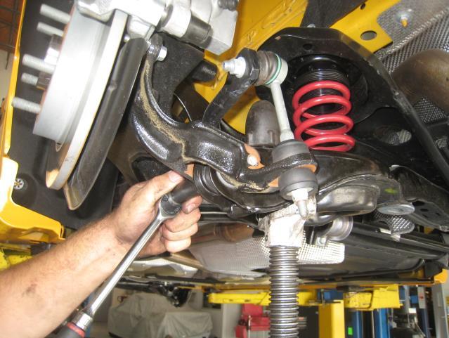 13. Preload the suspension using a screw or floor jack, then, tighten the lower control arm hardware. (See Photo 51) 14.