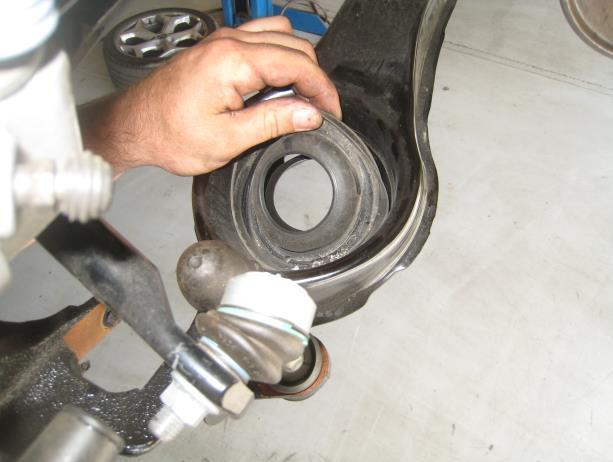 knuckle, then, remove the shock from the vehicle.
