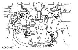17. Lower the steering column. 1. Remove the two steering column retaining nuts. 2.