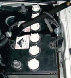 6. Place battery onto tray. Fit the J bolts and battery hold down clamp. Secure top mount between the J bolt closest to the engine and the inner guard as shown.