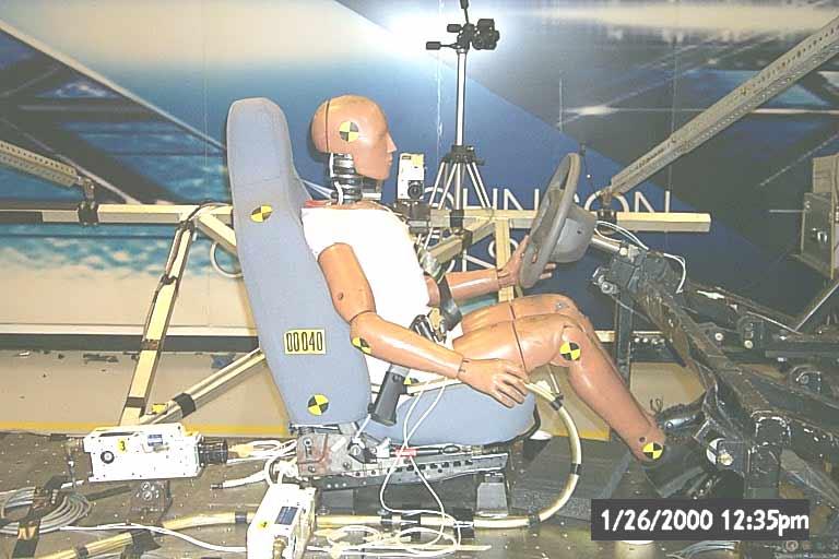 Sled Testing: The frontal impact sled test setup is shown in Figure 4. An instrumented 50 th percentile male Hybrid III dummy was seated on the AISS and restrained by the integrated seat belt system.