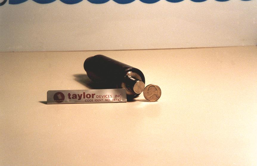 PHOTO 3 This is 1 piece of a Model 6186 Fluid Spring-Damper. This unit is also a standard Taylor product which is in production today. This Unit is a control sample that is kept in the Company Safe.