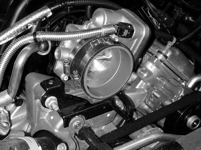 b) Secure the coupler to the throttle body with supplied hose clamps.