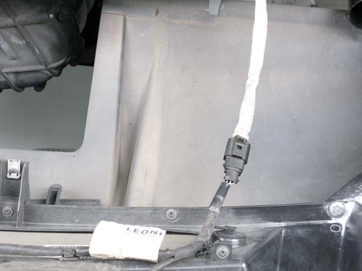 8. Carefully partially remove the bumper trim panel, disconnect the marked electrical connector and completely remove the bumper trim panel off the