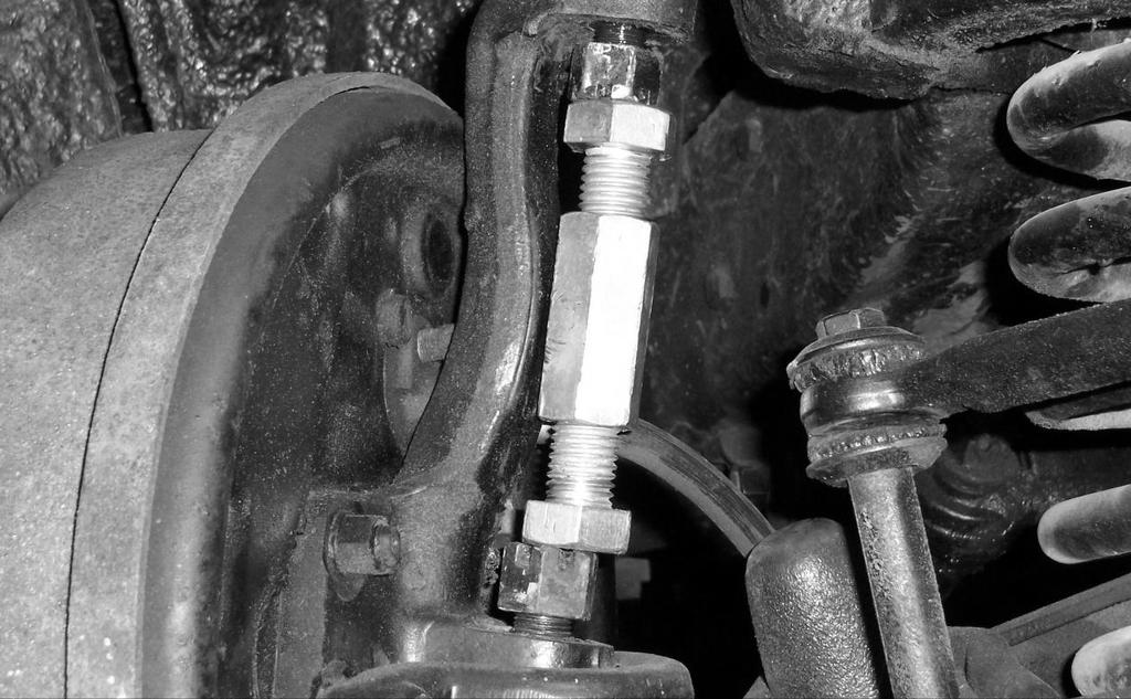 Place the tool between the ball joint studs, and turn a bolt to expand the tool, gently popping the ball joint studs loose.